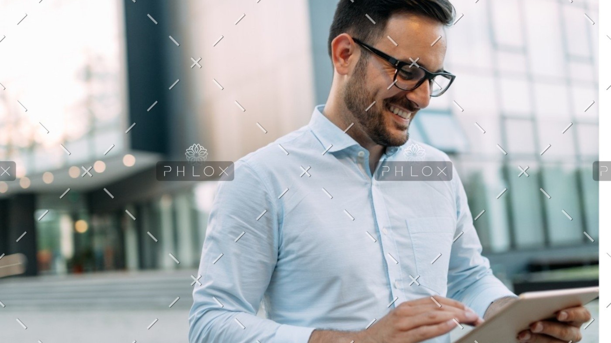 demo-attachment-609-portrait-of-businessman-in-glasses-holding-tablet-AWVHCJU
